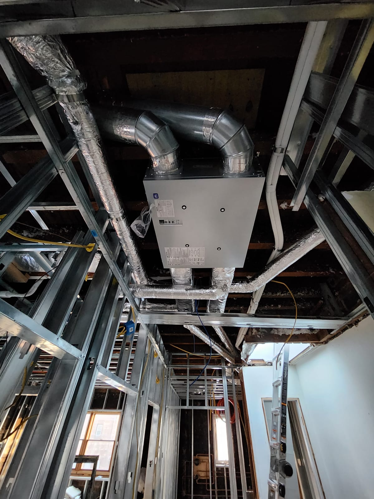 Room under construction with recessed ceiling vents and ductwork