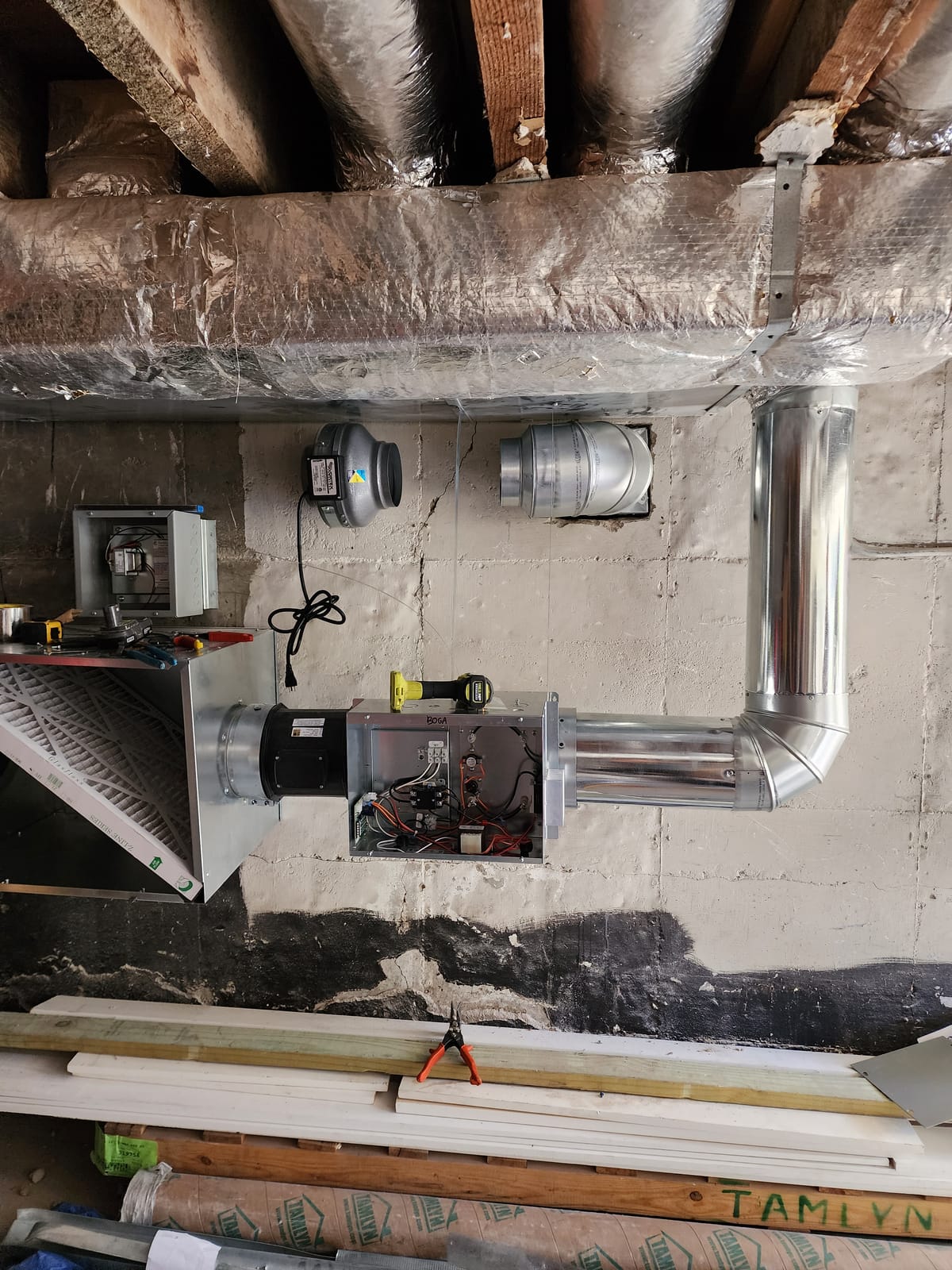 Basement air handler with fresh air ventilation ductwork