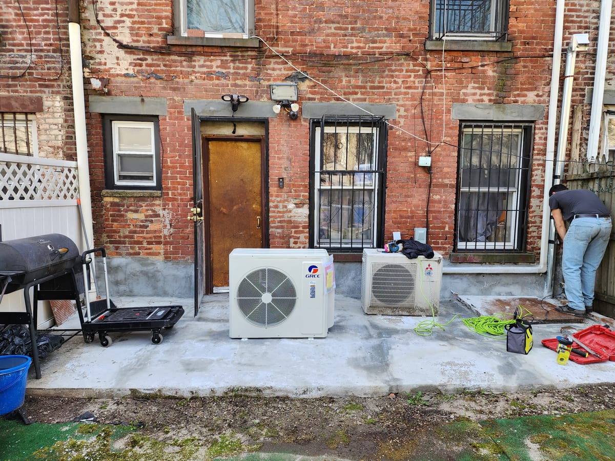 LG mini split wall unit in commercial space with tin ceiling