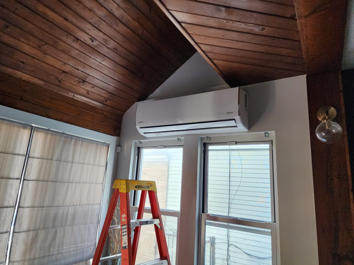 Daikin mini split wall unit under vaulted wood ceiling