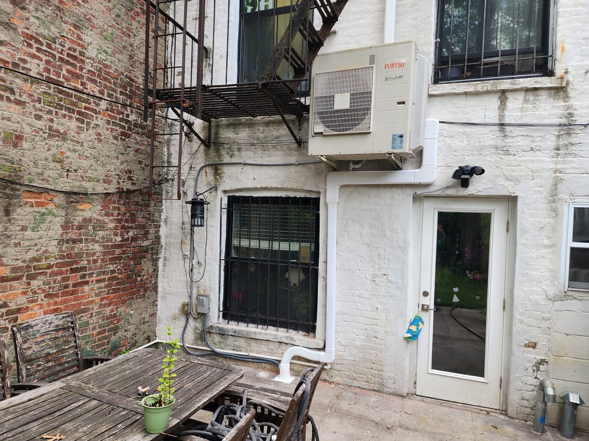 Fujitsu outdoor unit on Brooklyn brownstone wall