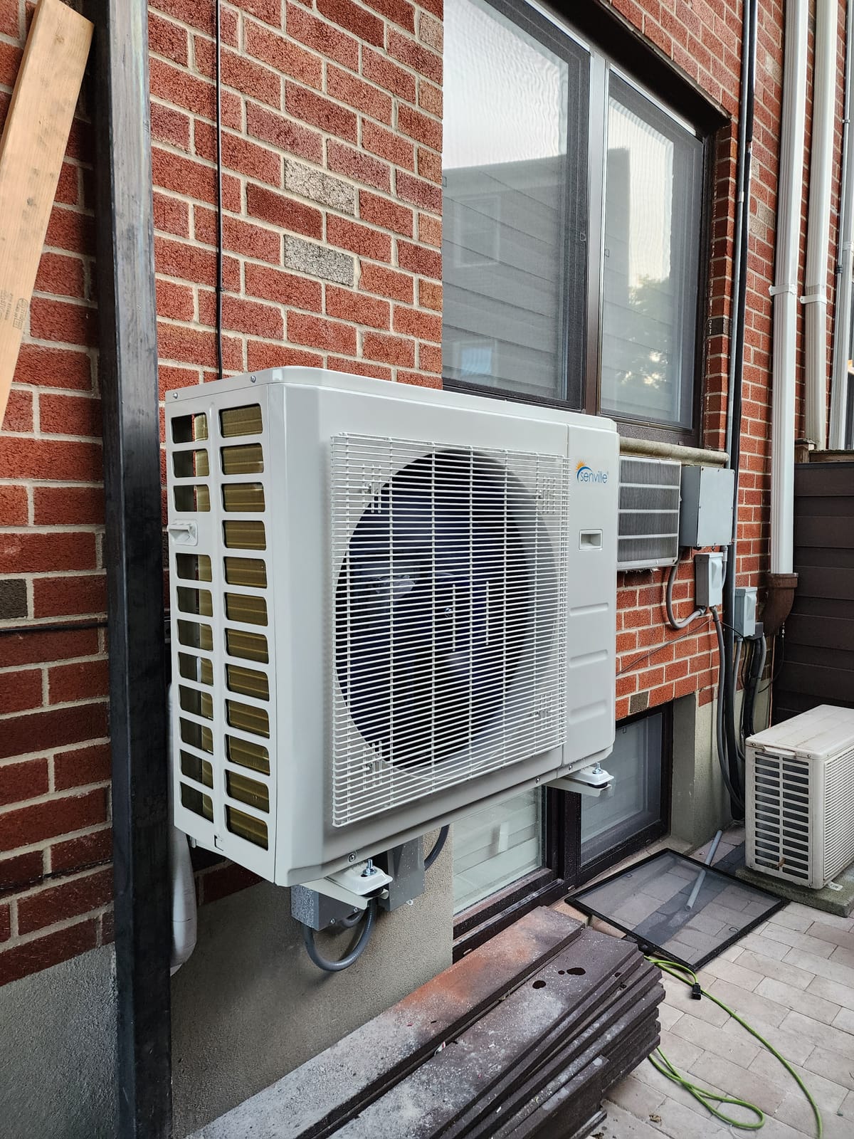 Condenser on brick building rooftop