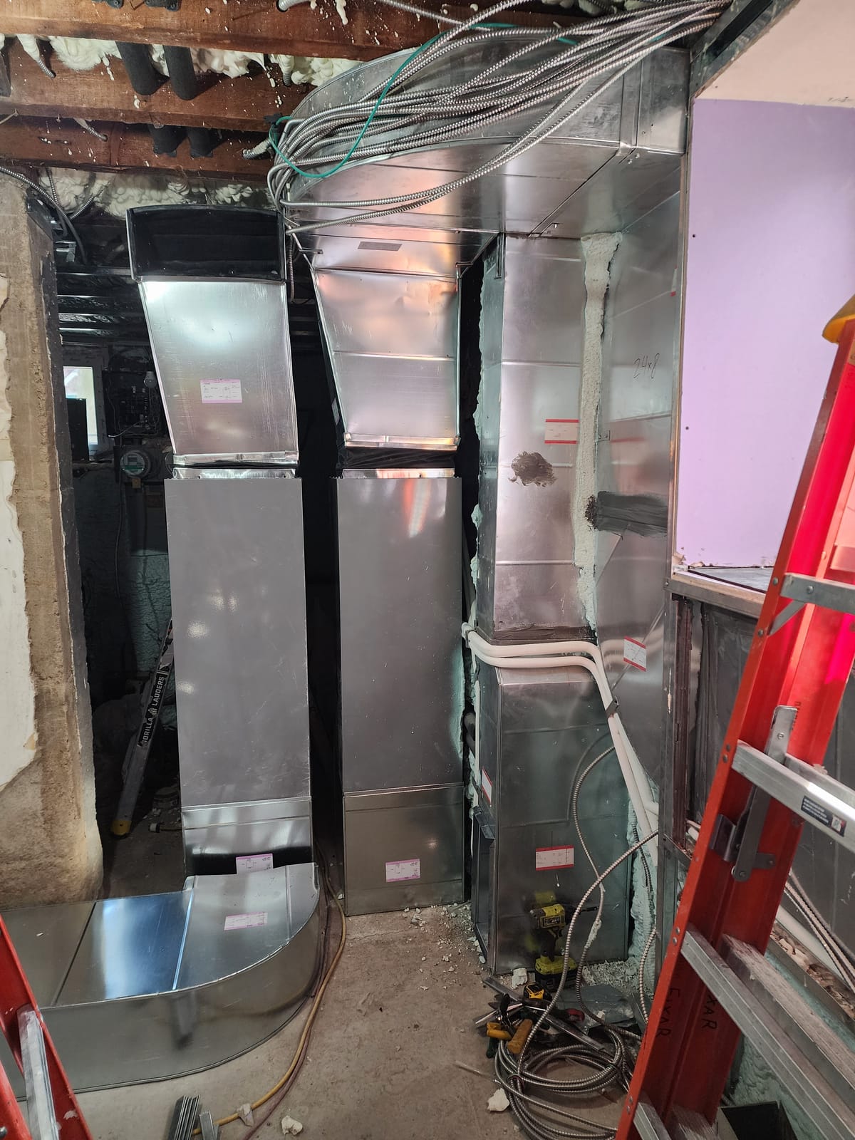 Bathroom ceiling opened showing ductwork above marble tile